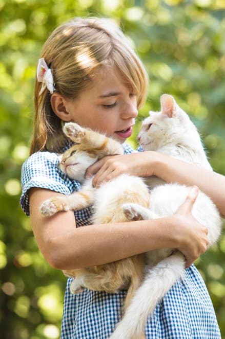 Girl with two kittens